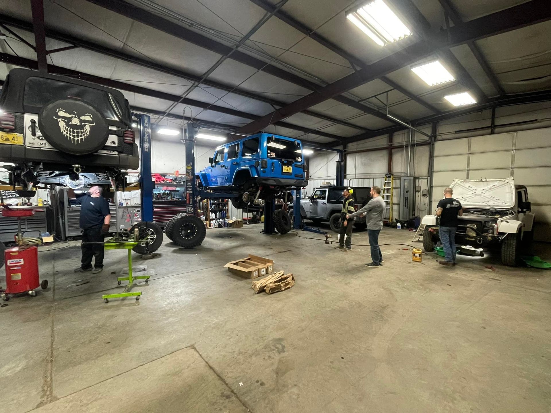 JB Autoworks mechanic shaking hands with a customer in the shop